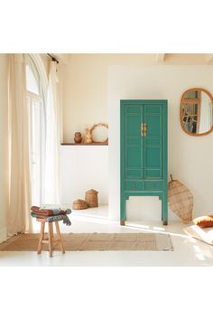 a green cabinet sitting in the middle of a living room