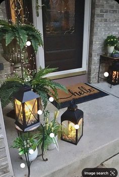 two lanterns are sitting on the front porch