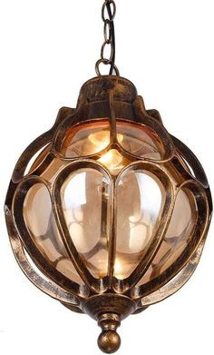 an old fashioned light fixture hanging from a chain