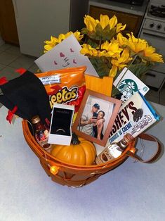 a basket filled with various items sitting on top of a counter next to a flower pot