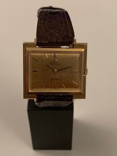 A rare opportunity to acquire a 1965 18k solid gold Omega Geneva gold watch Unusual shape of the case, fully hallmarked for 18k solid gold. This watch is supplied with the iconic Omega 622 caliber movement. Perfect working order and time keeping. After market leather band Original Omega buckle. I will include the original leather Omega band, which is deteriorated due to time. The watch is 29/26mm in dimensions! Hand winding mechanism! Original box! There are some minor blemishes on the 18k gold Yellow Gold Watches With Chronometer And Rectangular Dial, Formal Yellow Gold Watch Accessories With Rectangular Dial, Gold Rectangular Chronometer Watch, Formal Yellow Gold Analog Watches And Jewelry, Formal Yellow Gold Analog Jewelry And Watches, Gold Chronometer Watch Timeless Style, Luxury Business Watches With Gold Clasp, Gold Rectangular Watch Accessories With Chronometer, Antique Yellow Gold Watches For Business