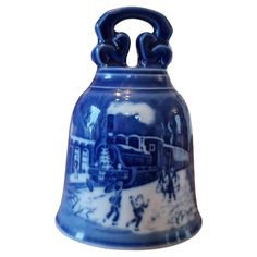 a blue and white bell with a train on it