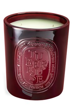 a red glass candle with the words luber fuse on it's side