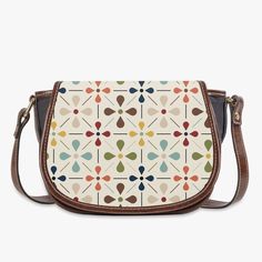 Carry a piece of Scandinavian chic with our Danish Modern Floral Saddle Bag. This mid-century inspired crossbody handbag adds a touch of vintage charm to any outfit. Compact yet spacious, it's perfect for on-the-go style. Bring out your inner flower child today! Key Features ✅ Made of premium PU leather fabric. ✅ Durable adjustable shoulder strap for various occasions. ✅ Classic Flap type & Smooth top zipper closure. ✅ Ultra-large interior capacity, big compartment with 3 pockets for the storage of daily must-haves. Retro Saddle Shoulder Bag With Detachable Strap, Retro Satchel Saddle Bag For Everyday Use, Retro Crossbody Saddle Bag For Travel, Retro Beige Satchel With Detachable Strap, Beige Retro Satchel With Detachable Strap, Retro Travel Saddle Shoulder Bag, Retro Saddle Shoulder Bag For Travel, Retro Shoulder Saddle Bag For Travel, Retro Brown Saddle Shoulder Bag