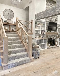 a living room filled with furniture and a fire place next to a tv mounted on a wall