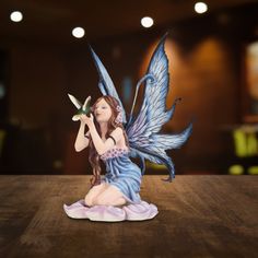 a figurine sitting on top of a wooden table