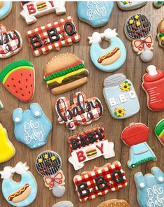 many decorated cookies on a wooden table with the words bbq and baby written in them