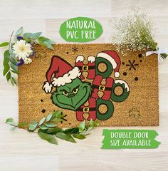 the door mat is decorated with an image of a green dragon wearing a santa hat