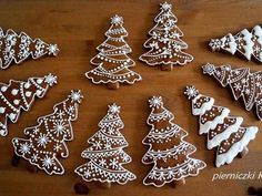 decorated cookies arranged in the shape of christmas trees and snowflakes on a wooden table