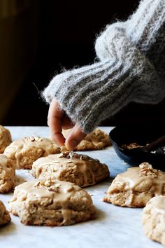 a person picking up some cookies from a tray