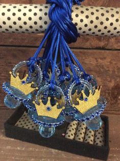 a blue and gold crown on top of a black stand next to polka dot fabric