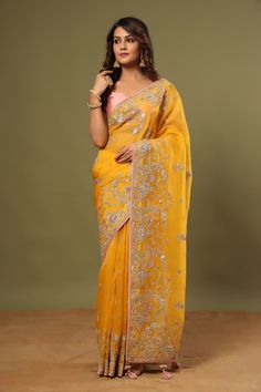 Look royal in this gorgeous mango yellow embroidered organza saree on festive occasions! It comes with a blouse piece. Disclaimer: The actual product may vary slightly from the image. These are custom orders, hence expect slight variation in color, placement of the motif or buta. ESTIMATED DELIVERYBecause this is a custom order, it would take about 4 weeks from the date of purchase. RETURN POLICYThis product is a custom order and cannot be returned or exchanged. Yellow Pre-draped Saree With Resham Embroidery, Yellow Anarkali Style Pre-draped Organza Saree, Yellow Pre-draped Saree With Resham Embroidery For Festive Occasions, Yellow Pre-draped Saree With Resham Embroidery For Navratri, Yellow Chanderi Traditional Wear For Reception, Yellow Pre-draped Saree With Resham Embroidery For Festive, Yellow Pre-draped Saree With Dupatta For Reception, Yellow Resham Embroidered Pre-draped Saree For Festivals, Yellow Semi-stitched Pre-draped Saree With Resham Embroidery