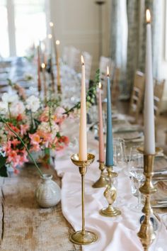 a long table with candles and flowers on it