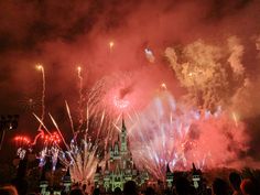 fireworks light up the night sky over a castle