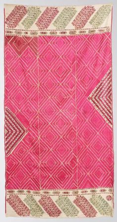 an old pink and green cloth with geometric designs