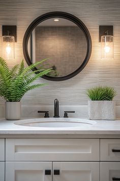 a bathroom sink with a mirror above it and two plants on the counter next to it