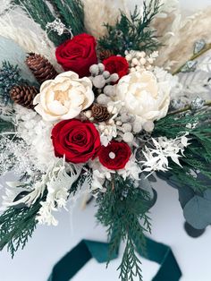 a bridal bouquet with white and red flowers