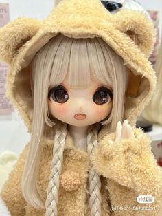 a doll with long hair wearing a teddy bear outfit