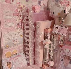 hello kitty merchandise is displayed on display in a shop window, with pink and white accessories