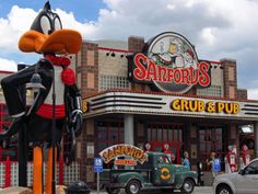 a goofy duck statue stands in front of the safford's grub and pub