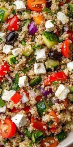 a salad with tomatoes, cucumbers, olives, and feta cheese