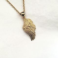 women's and men's angel wing necklace pendant 1 L 31.0mm made in 14k solid gold or 18k solid gold both side of it has same design with exquisite details. - this angel wing pendant height is L 31.0mm without the bail. - the angel wing necklace pendant 1 M 24.2mm and L 31.0mm are on our store. - model wears a 2.1mm 50cm chain. - materials: real 14k solid gold, real 18k solid gold - free shipping on all orders - designed by carre d'or - made in south korea 14k gold angel wing pendant necklace 1 L weight pendant only 5.43g (±3%) with a 1.7mm chain 42cm 9.51g (±3%) with a 2.1mm chain 42cm 11.39g (±3%) with a 2.4mm chain 42cm 13.26g (±3%) 18k gold angel wing pendant necklace 1 L weight pendant only 6.47g (±3%) with a 1.7mm chain 42cm 10.85g (±3%) with a 2.1mm chain 42cm 12.87g (±3%) with a 2.4mm Sterling Silver Gold Angel Wings Jewelry, Gold Sterling Silver Jewelry With Angel Wings, Gold Winged Sterling Silver Jewelry, Mens Necklace Pendant, Gold Angel Wings, Angel Wing Necklace, Angel Wing Pendant, Gold Angel, Mens Necklace