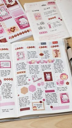 an open book with pink and red designs on the pages, sitting on top of a wooden table