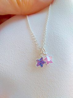 "925 Sterling Silver star charm necklace. One charm is an amethyst and the other one is rose quartz. If you prefer a different stone combination, please contact us! Please choose your favorite necklace length at checkout. All lengths have a one inch extender, that way you'll have some wiggle room to play with the length. For example, if you choose a 14 inches necklace length, you'll have options to close the necklace at any length between 14 inches and 15 inches. Some of this charms are sold by Silver Star-shaped Dainty Jewelry, Silver Dangle Charm Necklace With Star Charm, Dainty Star-shaped Personalized Necklace, Dainty Personalized Star Necklace, Pink Sterling Silver Charm Necklaces, Pink Sterling Silver Personalized Charm Necklace, Silver Necklace With Star Charm Round Pendant, Silver Star Necklaces With Birthstone, Pink Sterling Silver Charm Necklace