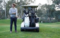 a man standing next to a golf cart