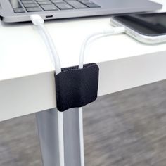 a laptop computer sitting on top of a white desk