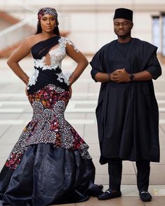 two people standing next to each other in formal wear and one is wearing a black dress