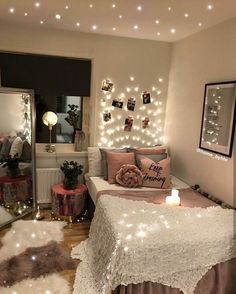 a bedroom with lights on the wall and a bed