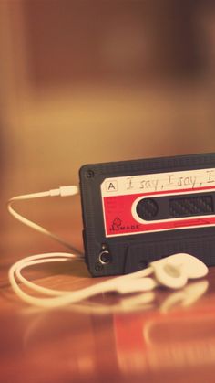 an old fashioned cassette player with headphones on top of it, sitting on a table