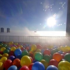 there are many colorful balloons in the water