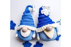 two crocheted blue and white gnomes with snowflakes