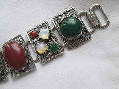 Beautiful vintage 1940s silver tone wide 5 link bracelet with gemstones, opal, jade, carnelian and amethyst in good vintage condition and measures 7 inches long by 1 1/4 inches wide. Vintage Natural Stones Gemstones For Gift, Vintage Natural Stones Gemstones As Gift, Vintage Natural Gemstones As Gifts, Vintage Multi-stone Bracelets Gift, Vintage Natural Gemstones, Vintage Multicolor Stone Bracelets, Vintage Natural Stones Gemstones, Vintage Round Natural Gemstones, Vintage Silver Multi-stone Jewelry