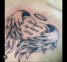 the back of a man's chest with an angel and heart tattoo on it