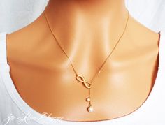 Your choice of gold or silver infinity and Swarovski pearl lariat style necklace. Simple, elegant and daintyHOW TO ORDER :* Choose gold or silver from the drop-down list above* Add to cart etcDETAILS:* Pearls are white Swarovski pearls and measure 3/16" and 5/16" (6mm and 4mm)* Necklace measures approximately 18" (46cm) with an extra 1.5" drop.  Your Zoe River jewellery will always arrive gift-wrapped and in a sweet little organza giftbag, carefully packaged to arrive safely. Please feel free to Elegant Infinity Necklace For Party, Elegant White Infinity Necklace, Lariat Style Necklace, Pearl Lariat, Necklace Elegant, Infinity Necklace, Necklace Simple, Dec 12, Swarovski Pearls