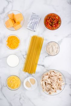 ingredients to make pasta laid out on a marble counter