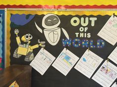 a bulletin board with pictures and writing on it that says out of this world in front of an image of a cartoon character