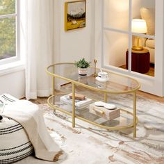 a living room scene with focus on the glass coffee table and white carpeted floor