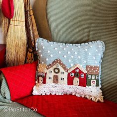 a red couch with a decorative pillow on it