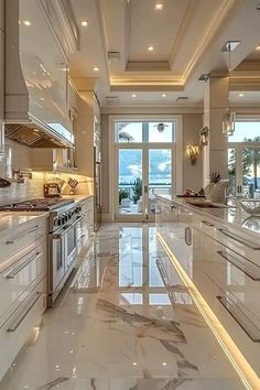 a large kitchen with marble counter tops and white cabinets