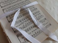 sheet music with white ribbon laying on top of it