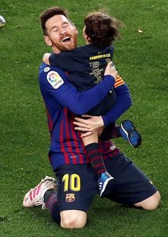 two soccer players are hugging each other on the field