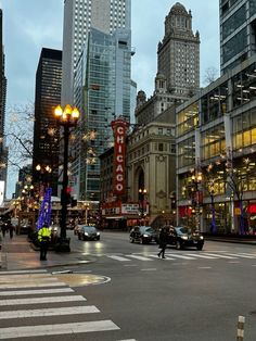 a busy city street with tall buildings in the background