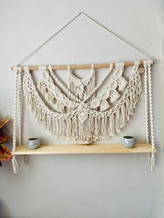 a macrame wall hanging on a shelf