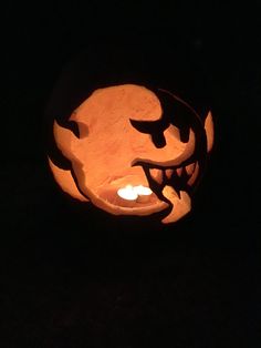 a carved pumpkin is lit up in the dark