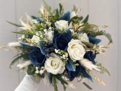 a bridal bouquet with white and blue flowers