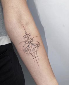 a woman's arm with a tattoo on it that has a flower in the center